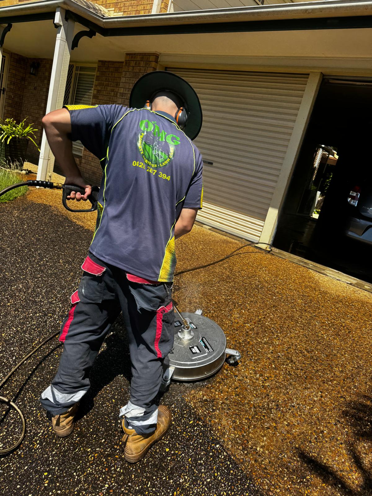 OMG Lawn Care pressure cleaning a Brisbane residential driveway